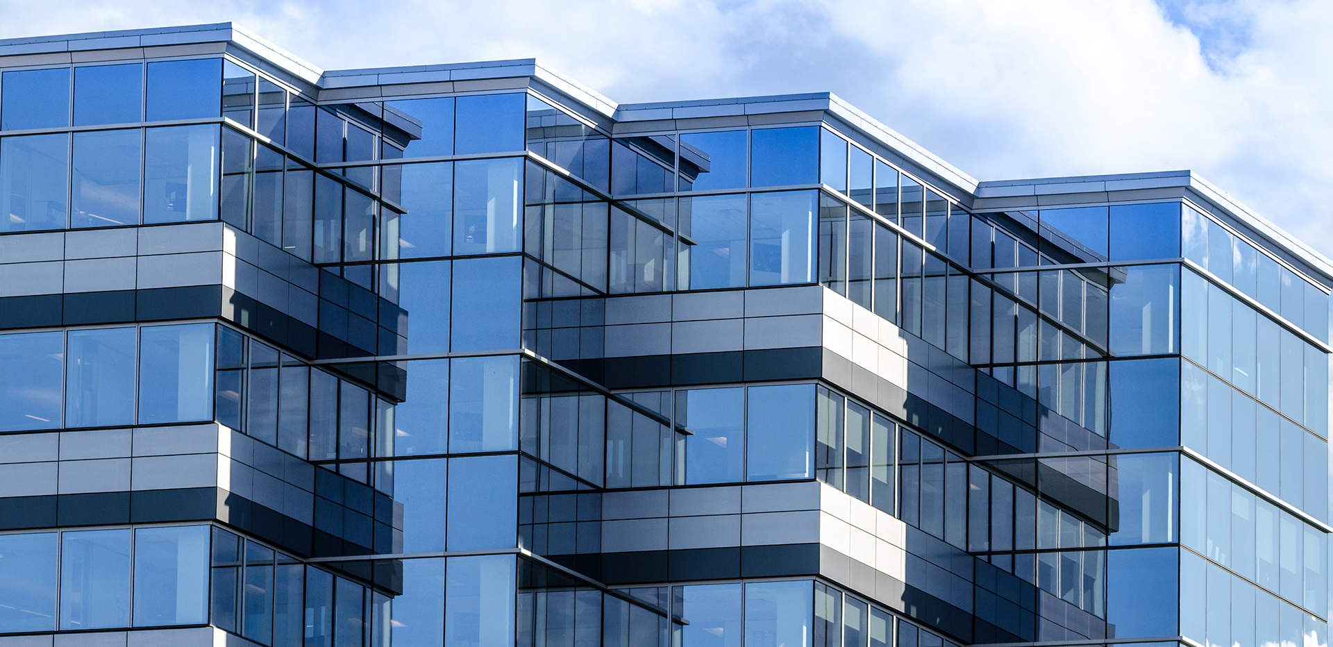 Modern commercial office building with glass facade and contemporary architectural design.