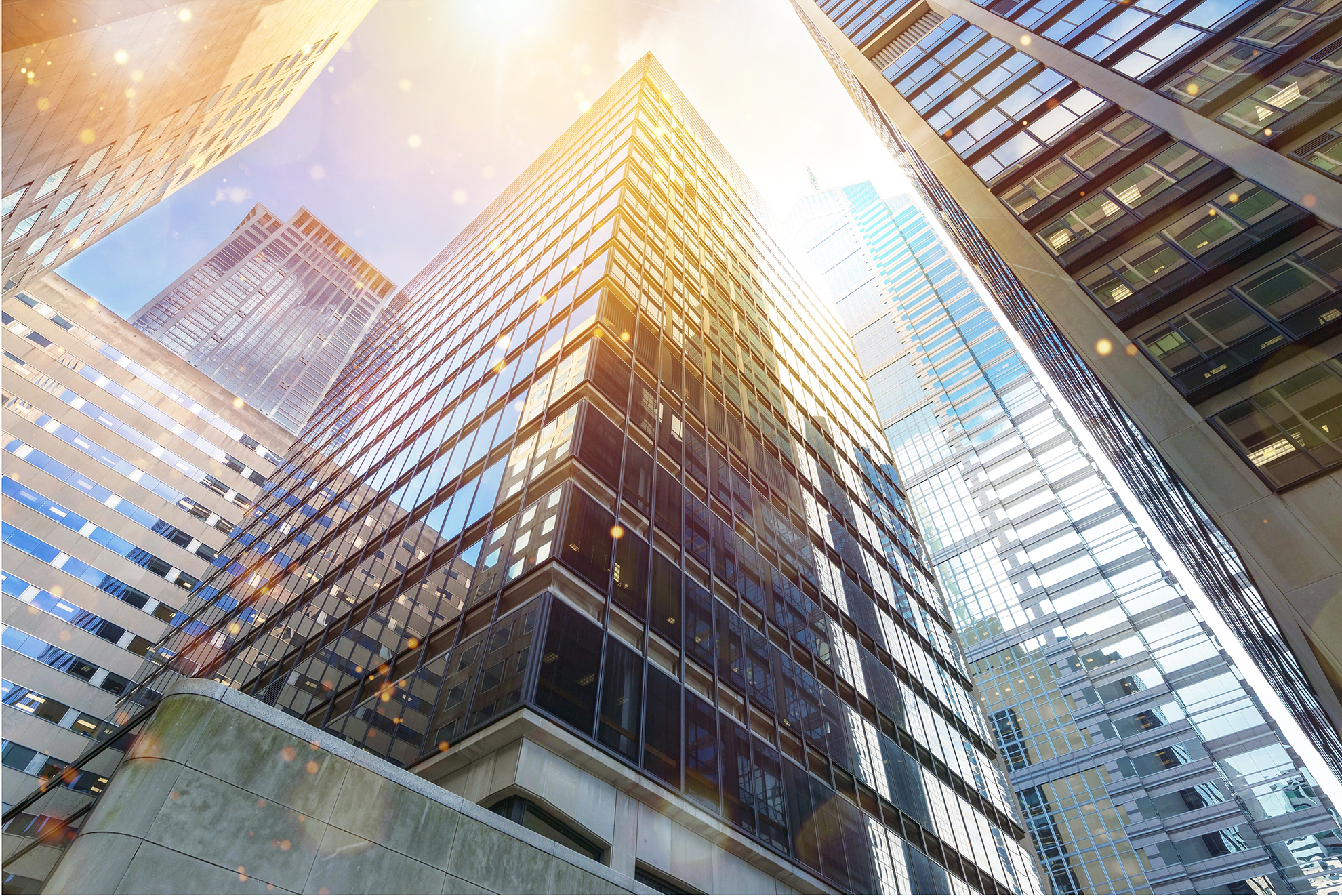 Modern high-rise commercial office towers with glass facades in a central business district.