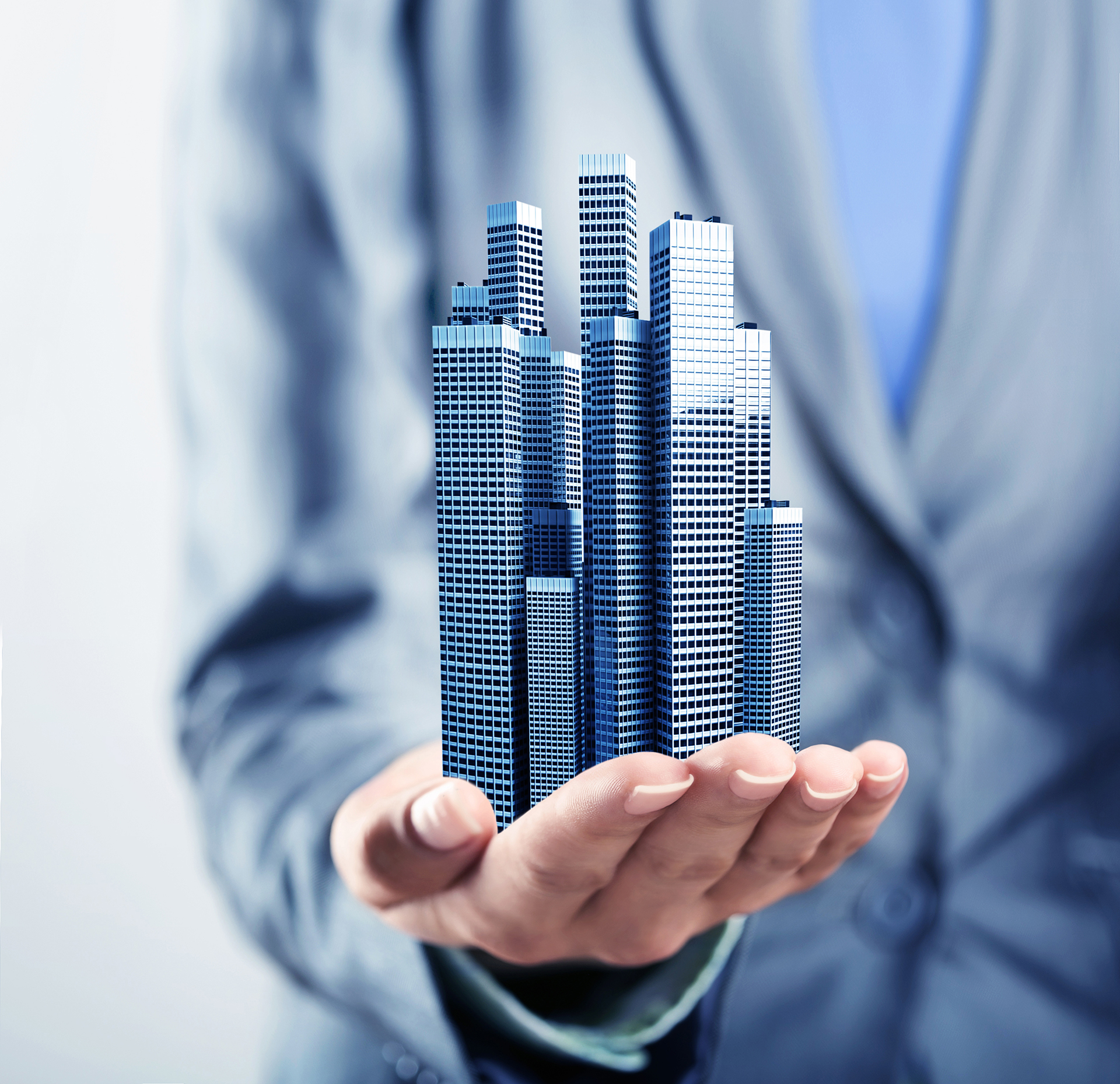 Professional holding a model commercial building representing governance, accountability, and responsible building management.