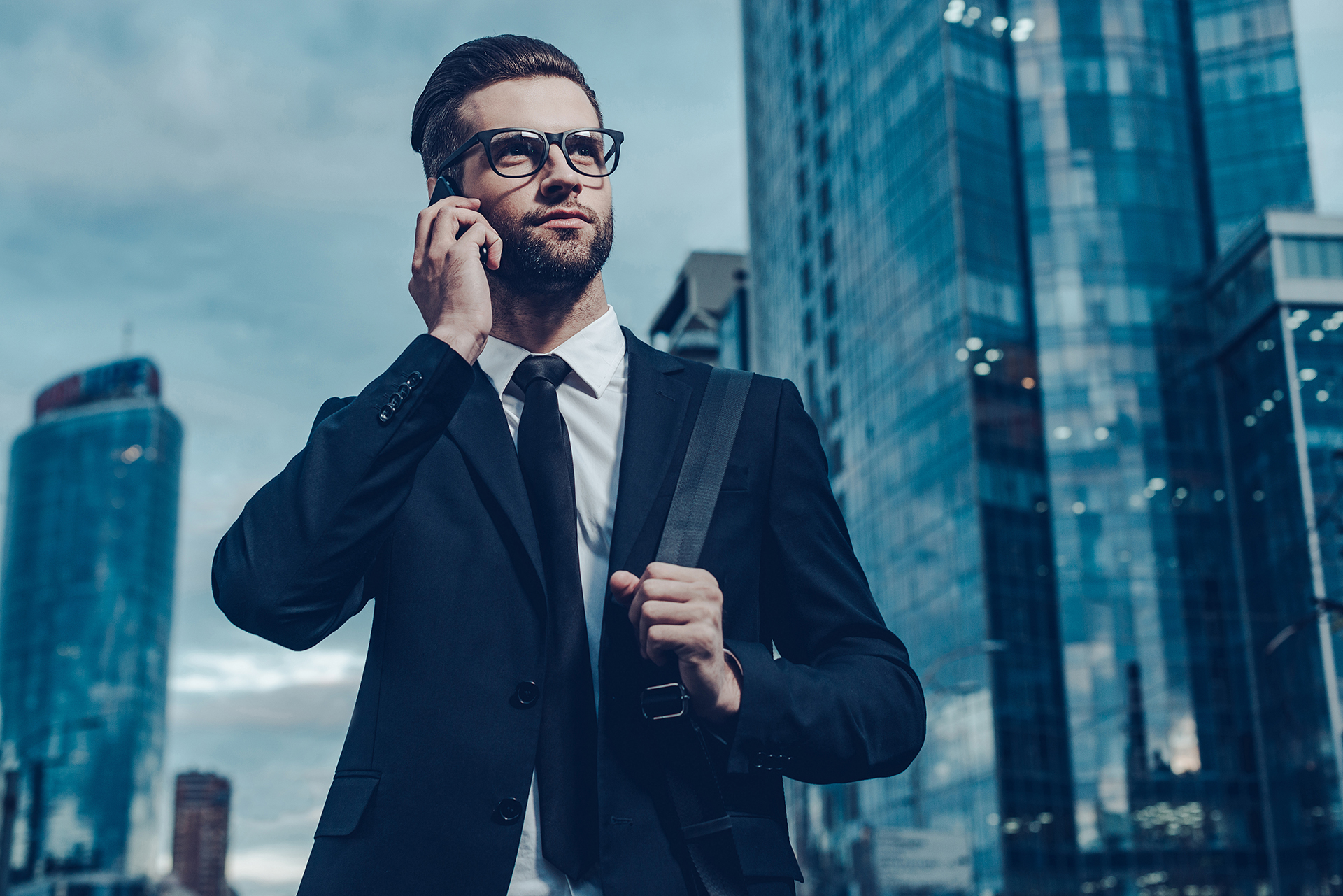 Commercial property manager standing in a city business district managing building operations and stakeholders.