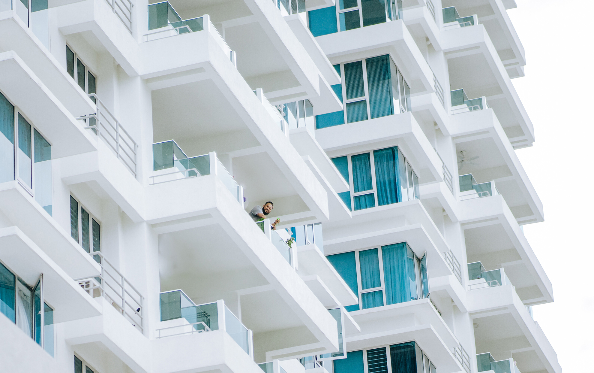 Modern residential apartment building with balconies and strata-managed units.