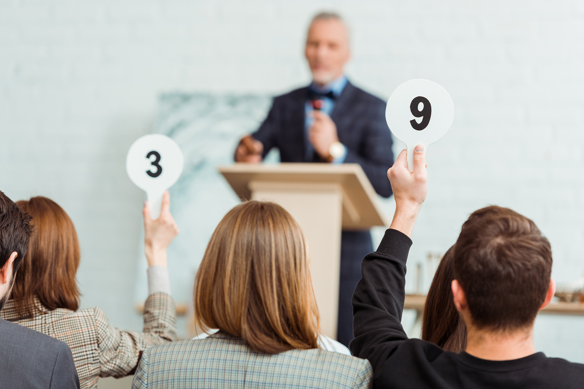 Stakeholders voting at a strata meeting highlighting the role of strata managers in protecting property values and managing building assets.